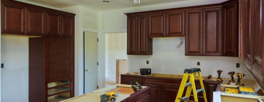 Installing new induction hob in modern Installation of kitchen cabinet. Kitchen Remodel Beautiful kitchen